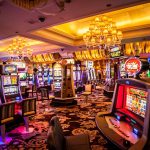 Interior of a brightly lit casino with slot machines