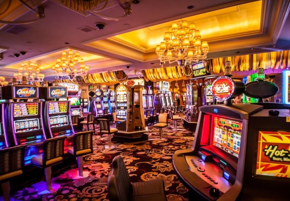 Interior of a brightly lit casino with slot machines