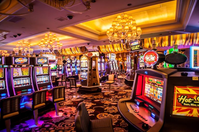 Interior of a brightly lit casino with slot machines