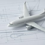 Model airplane on technical blueprint